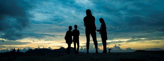 silhouette of people at landscape sunset in the sea